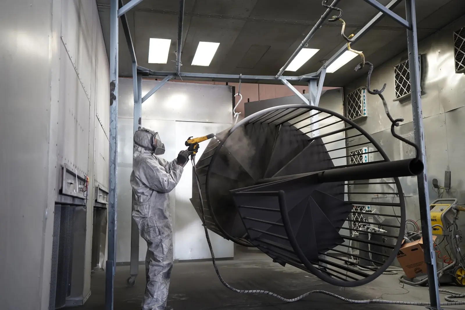 Industrial powder coating being applied to a large fabricated component